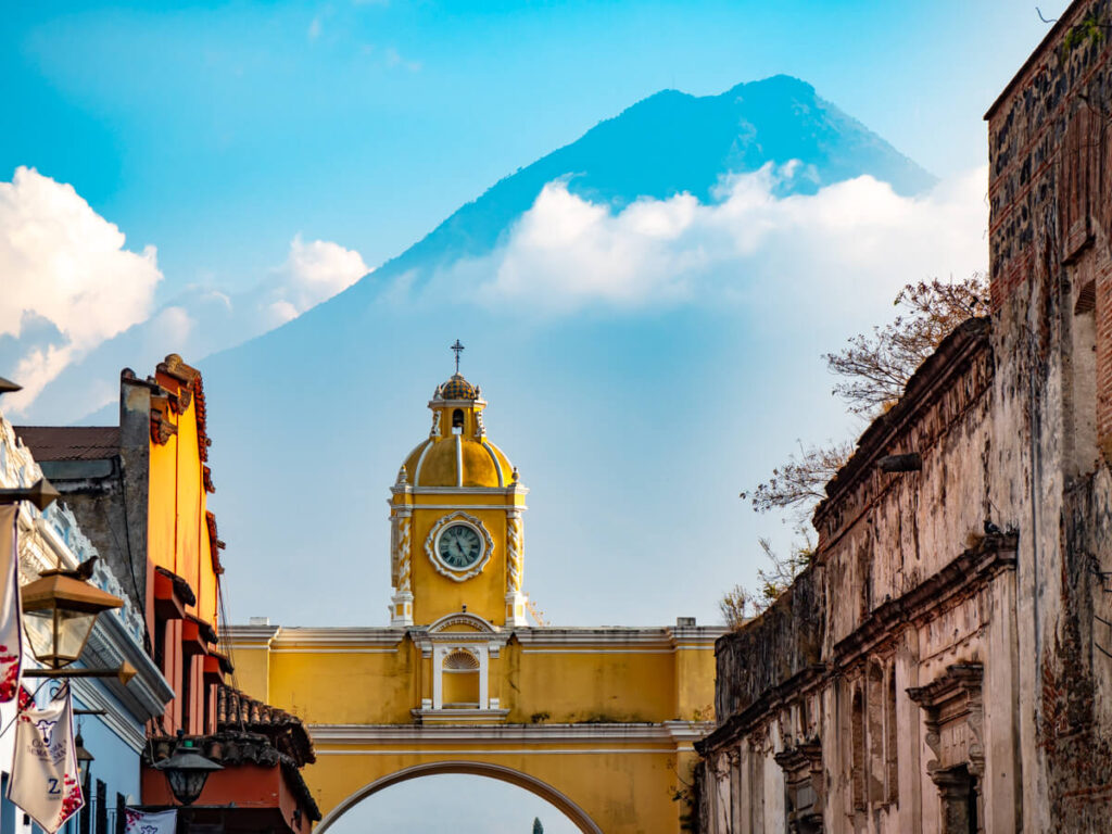 Antigua Guatemala's Santa Catalina Arch with Volcán de Agua rising behind the colonial rooftops