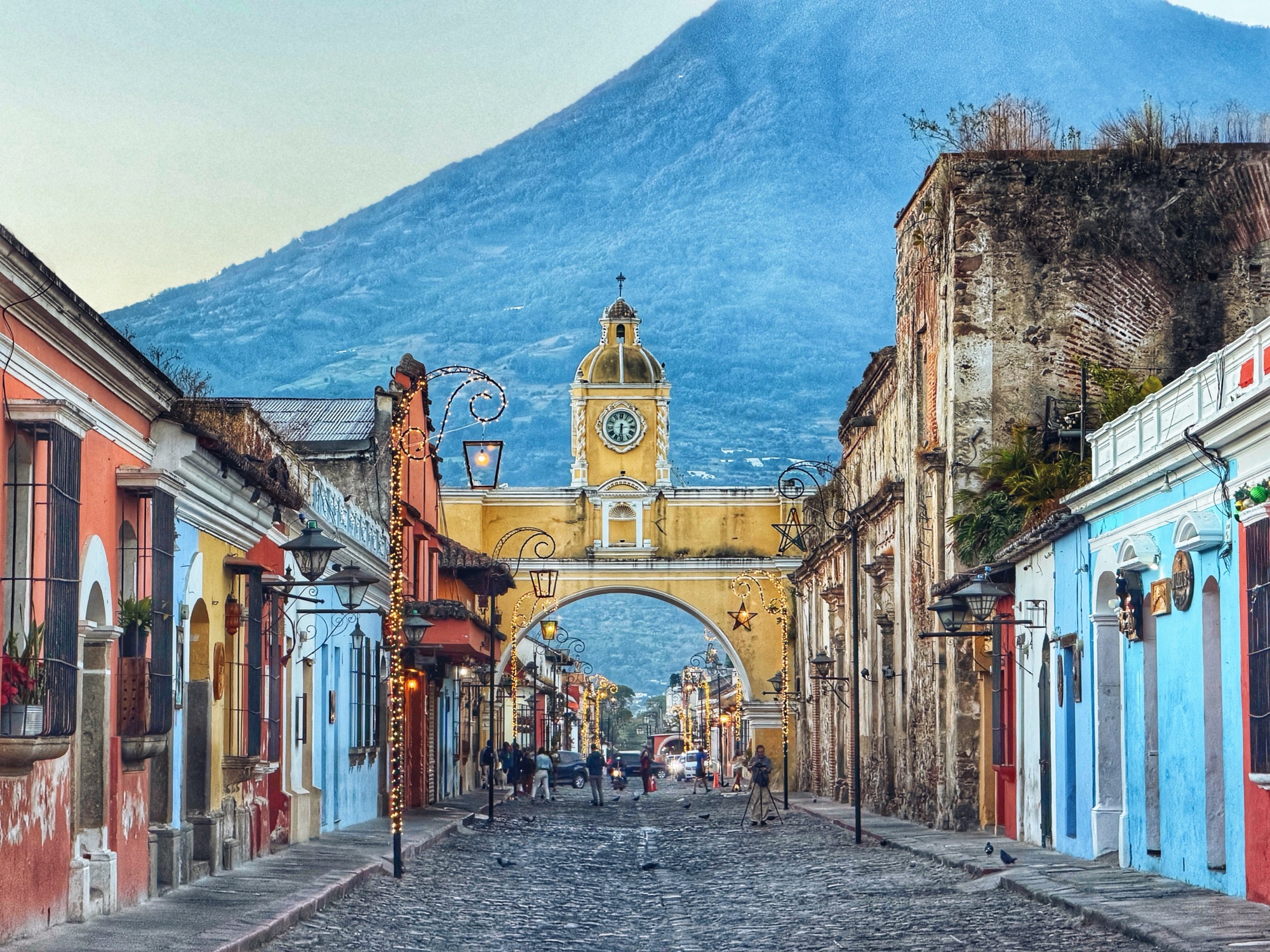 Arco de Santa Catalina em Antigua Guatemala emoldurando o Volcán de Agua no fim da rua de paralelepípedos