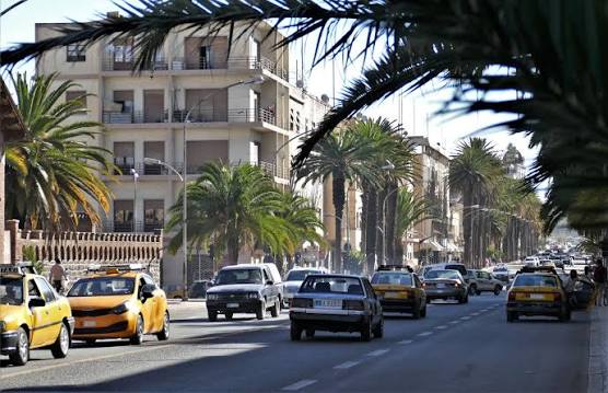 Art Deco buildings and palm trees along Harnet Avenue in Asmara, Eritrea