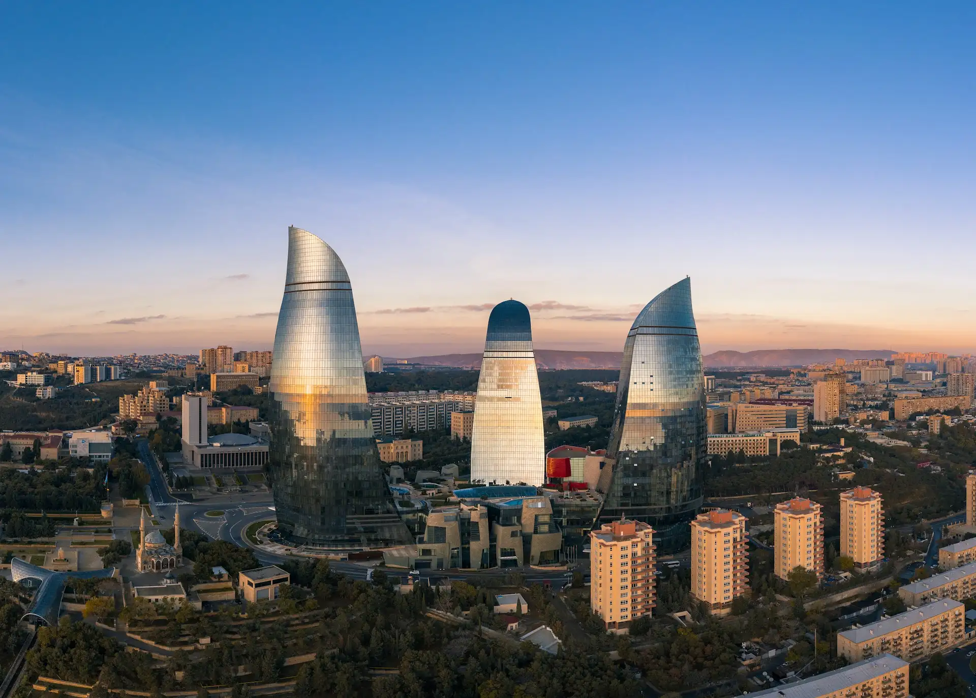 Baku's Flame Towers illuminated at night above the Caspian Sea boulevard