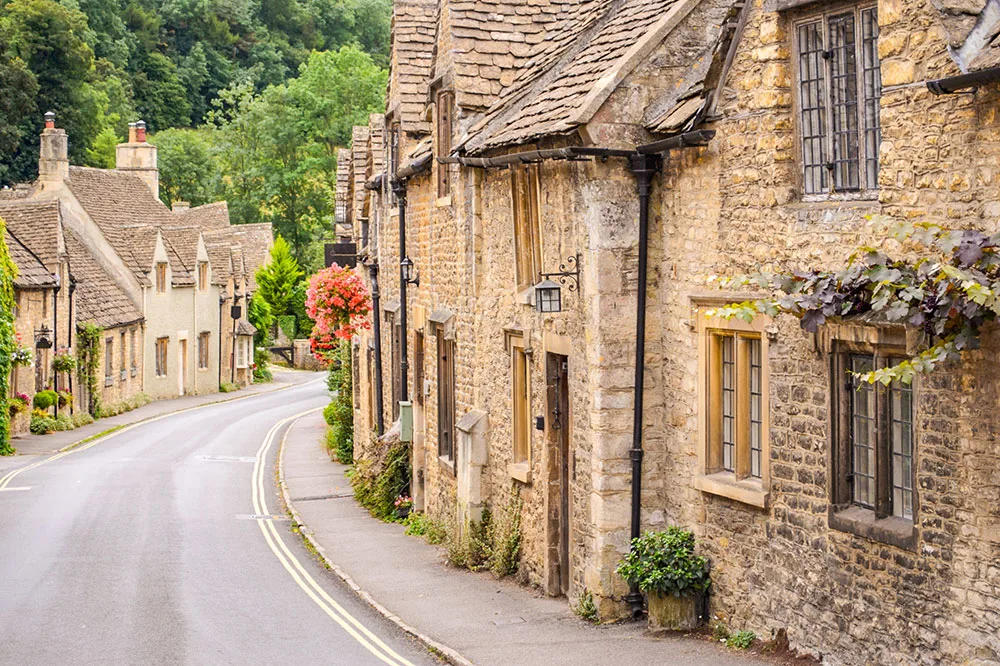 Honey-colored stone cottages in a Cotswolds village in the English countryside