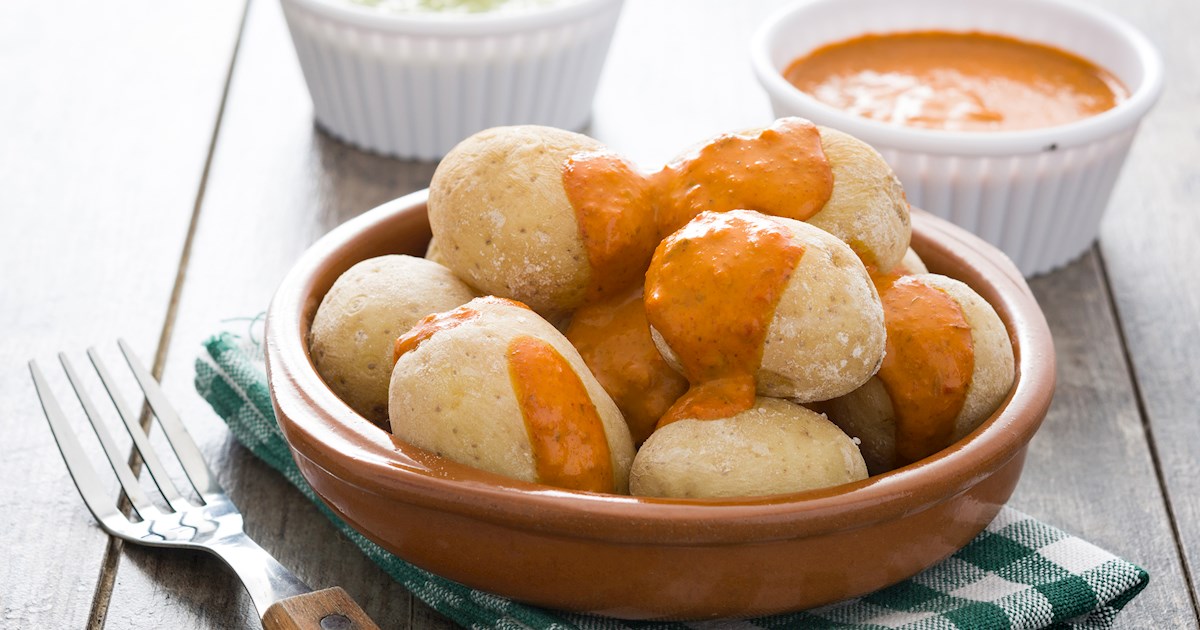 Papas arrugadas with mojo sauce and fresh fish on a table in Gran Canaria