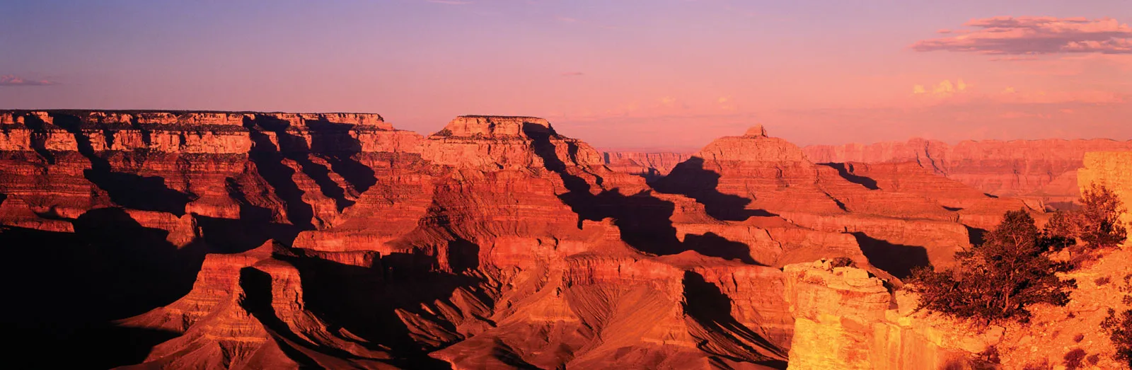 Layered red rock walls of the Grand Canyon at sunset from the South Rim