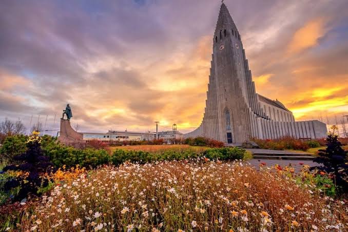 Reykjavik Iceland with the Hallgrimskirkja church tower above colourful rooftops on a clear day