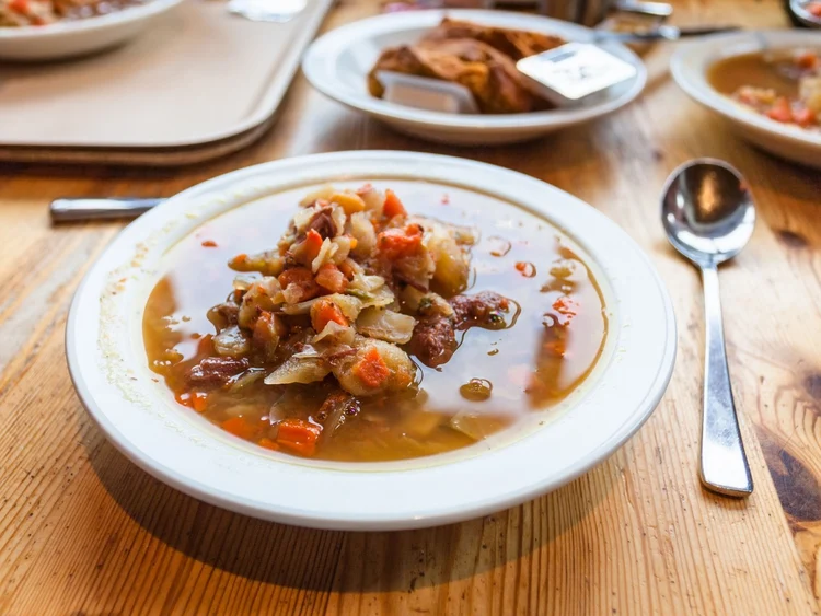 Icelandic lamb soup and skyr with fresh bread on a rustic wooden table