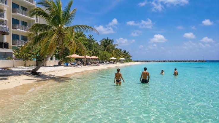 Bikini Beach on Maafushi island, Maldives, with turquoise water and palm trees