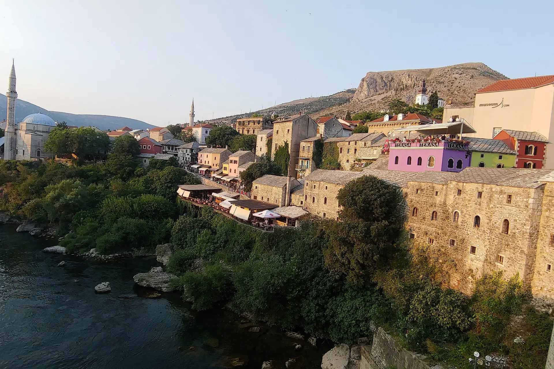 Mostar's old town above the Neretva River at sunset, seen from the Old Bridge
