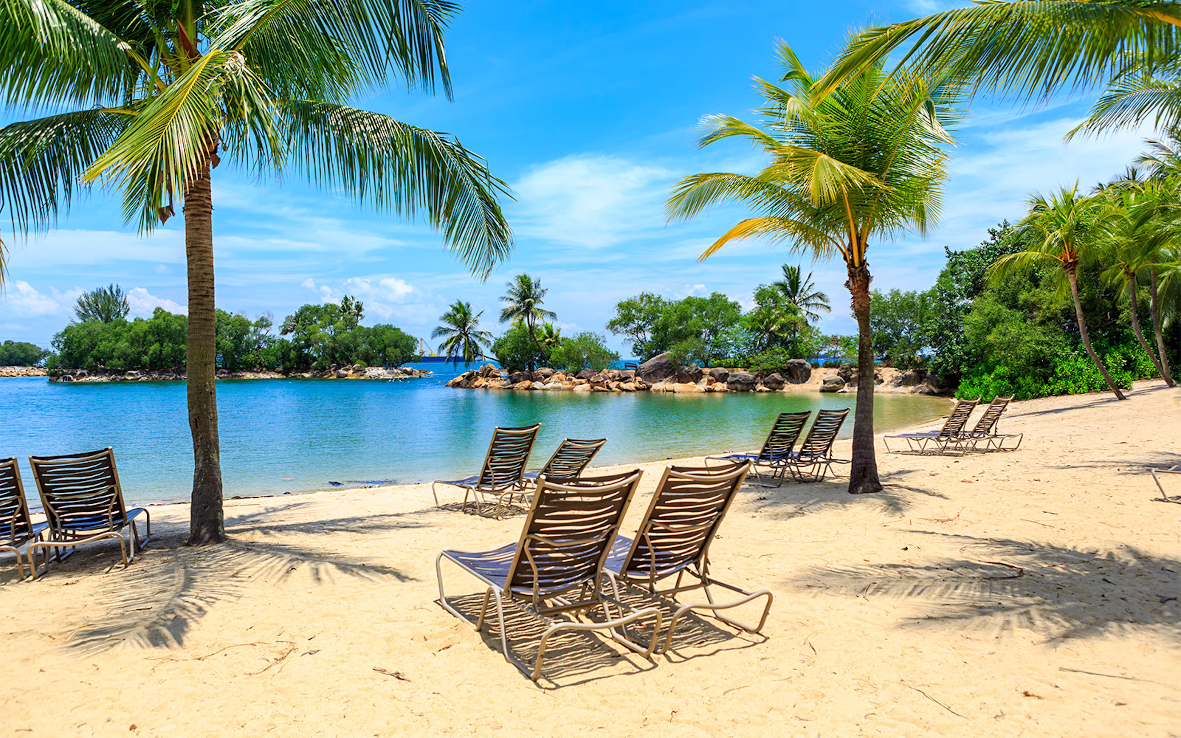 Siloso Beach on Sentosa Island, Singapore, with sun loungers and beach bars