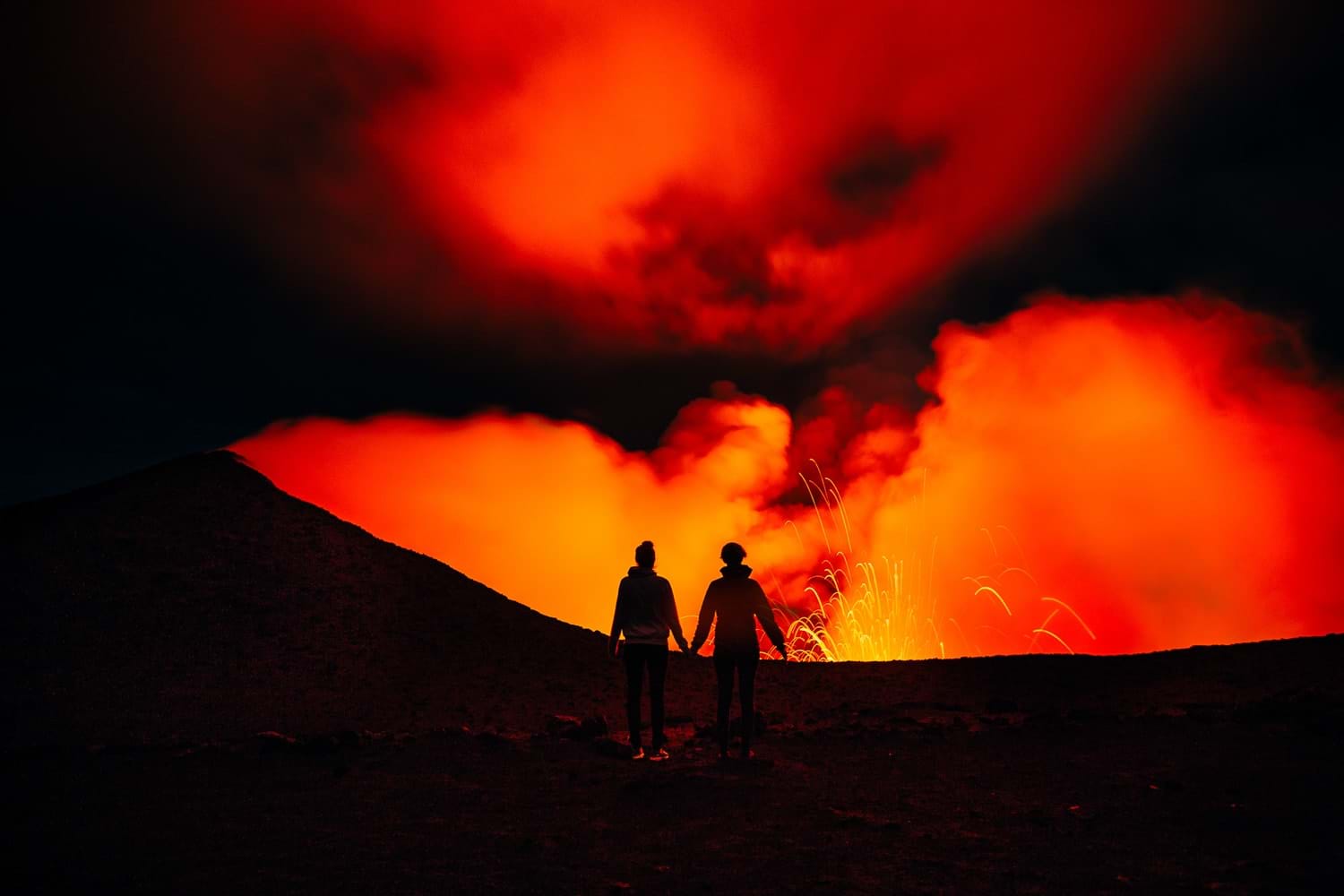 Strombolian eruption glowing orange inside the crater of Mount Yasur on Tanna island, Vanuatu, at dusk